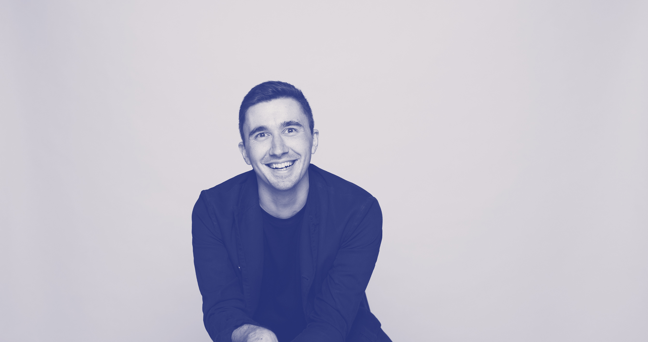 Чёрно-белая фотография. Администратор баз данных Андрей улыбается.